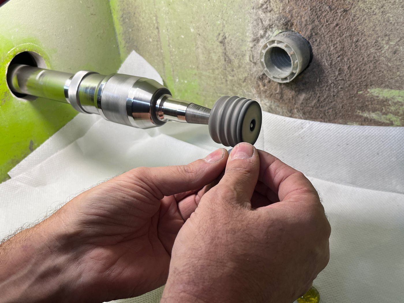 Hands rinsing a piece at the bench