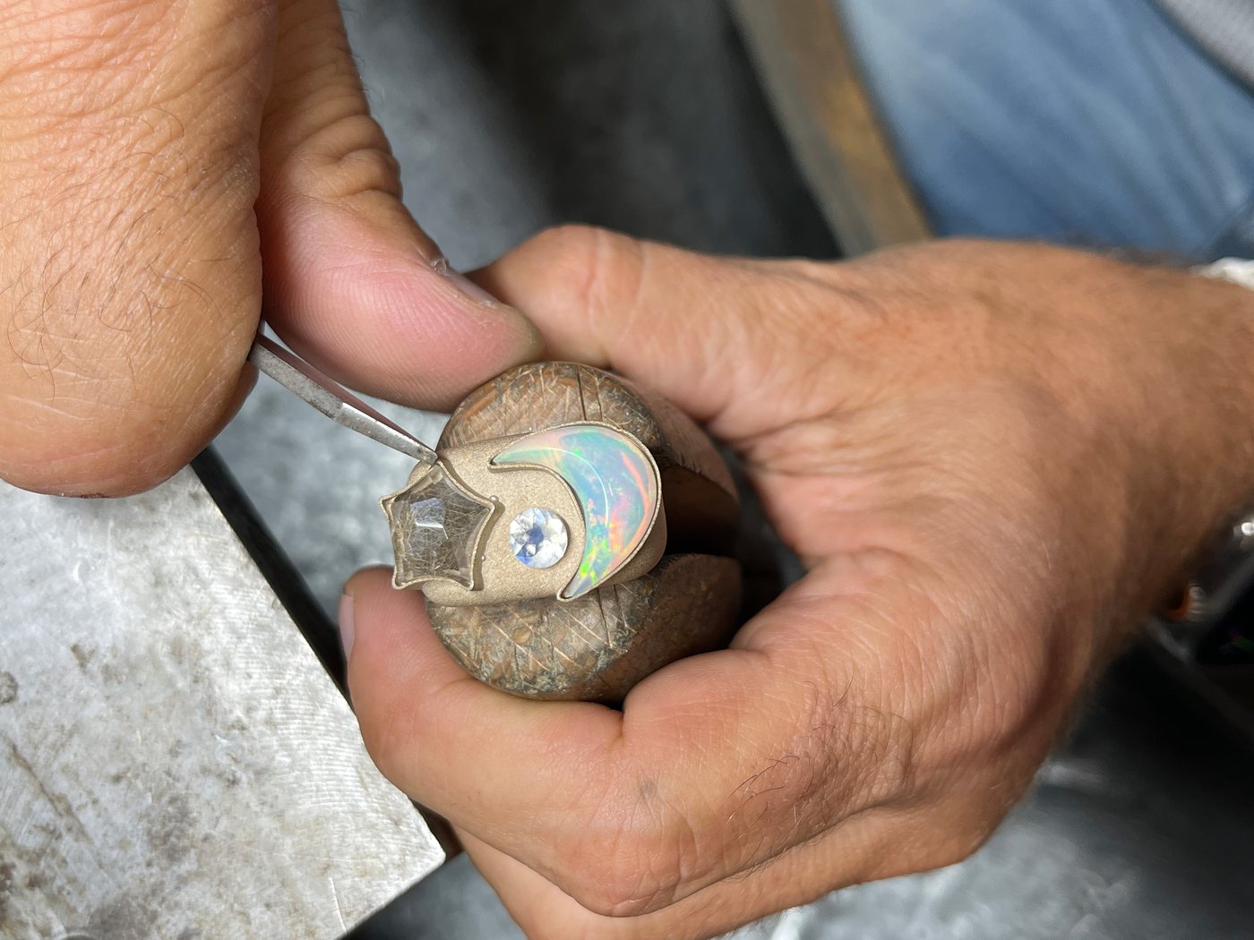 A stone being set by hand