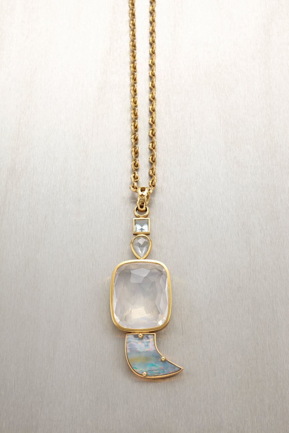 A moonstone pendant on a gold chain