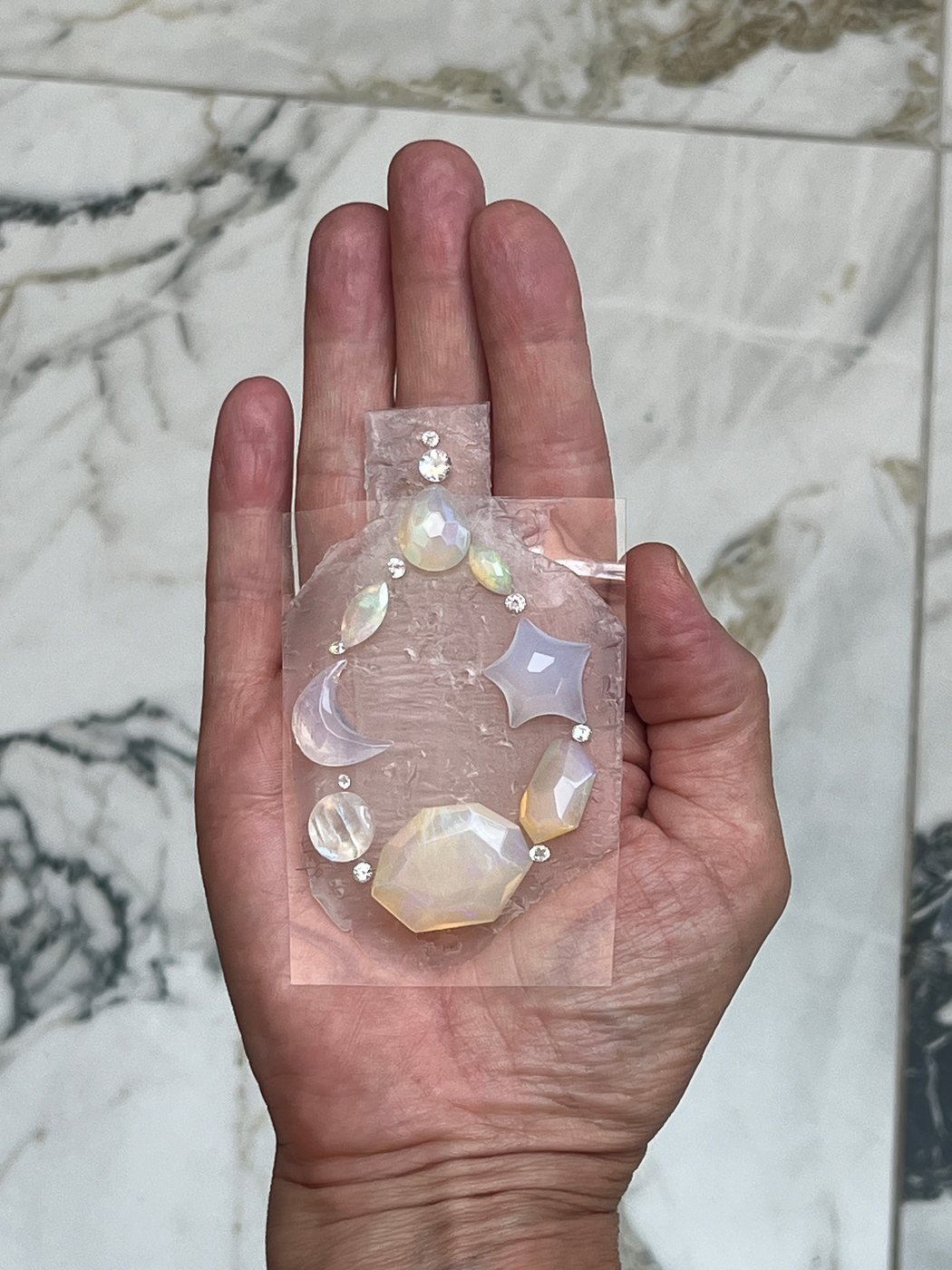 An opal held in the palm of a hand